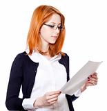 Portrait of a young business woman reading paper.