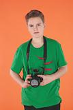 Boy with photo camera. Orange background