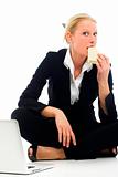 businesswoman eating sitting on the floor with laptop