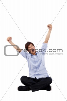 Happy Asian young man sitting and looking up
