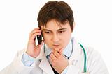 Concentrated medical doctor talking on mobile phone
