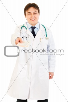 Smiling doctor giving medical prescription in hand
