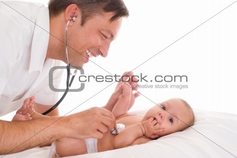Handsome doctor examining newborn 