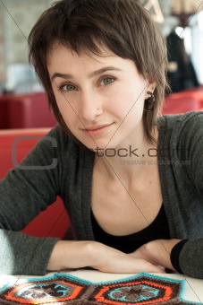 Portrait of a young beautiful girl with knitting