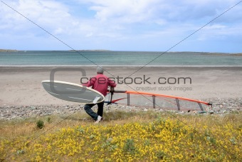 surfer with board ready to windsurf