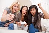 Three Beautiful Women Friends Playing Computer Games at Home