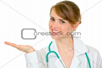 Smiling medical doctor woman presenting something on empty hand

