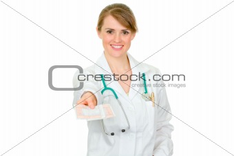 Smiling medical female doctor holding medical prescription in hand
