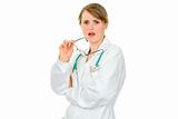 Shocked young female doctor holdin her glasses in hand
