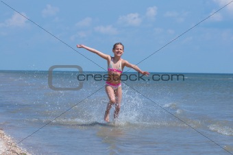 Happy Pretty beautiful girl running on beach