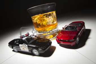 Police and Sports Car Next to Alcoholic Drink Under Spot Light.