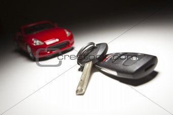 Car Keys and Sports Car Under Spot Light.
