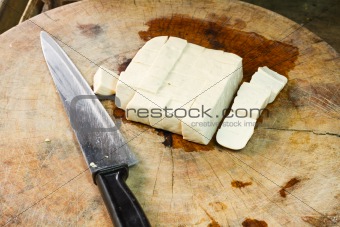 Tofu on wooden cutting board.