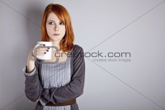 Portrait of red-haired girl with cup. 