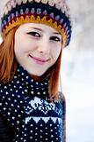 Beautiful young red-haired woman in winter park 