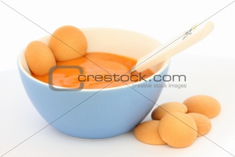 Red bowl with children fruit pap / mush with sponge-biscuits