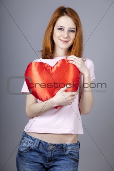 Beautiful red-haired girl with toy heart.