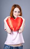 Beautiful red-haired girl with toy heart.