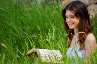 Beautiful young woman reading