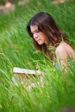 Beautiful young woman reading