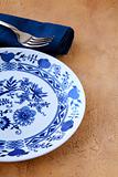 table setting a plate with a blue pattern and a blue clothtable setting a plate with a blue pattern and a blue cloth