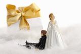 Wedding cake figurines with gift on white