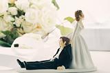 Whimsical wedding cake figurines on white