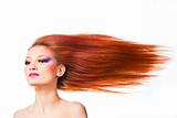 woman with long red hair fluttering on wind