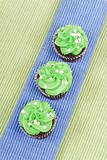 Top of Chocolate Cupcakes with Green Frosting on Blue Mat