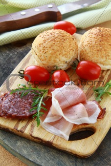 Assorted several kinds of sausages and smoked meats on a cutting board