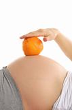 Pregnant woman's abdomen with orange