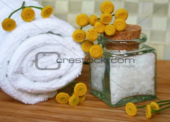 White bath towel, bottle of sea salt in spa composition