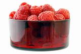 Rasperries in glass red bowl