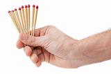 Hand with matches on a white background