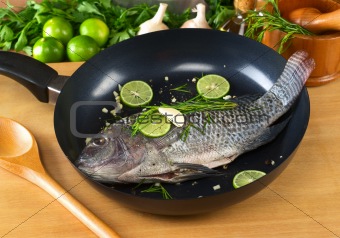 Raw Tilapia with Condiments in Frying Pan