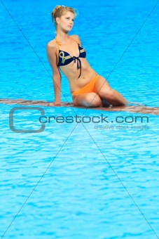 Woman near swimming pool 
