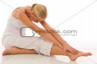 woman dressed in white sitting on the floor