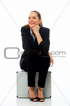 businesswoman sitting on a briefcase