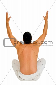 bare-chested man sitting on the floor with arms up
