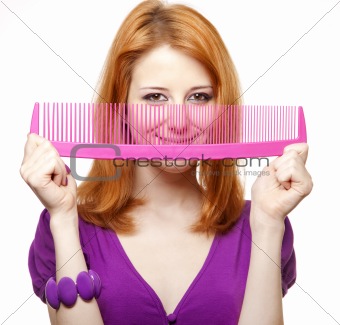 Funny red-haired girl with big comb.