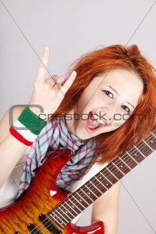 Smiling red-haired Italian girl with guitar