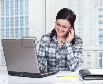 Woman with phone in office