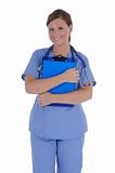 A female nurse with a friendly smile holding a clipboard.