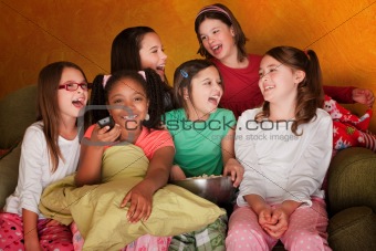 Group Of Little Girls Watch Television