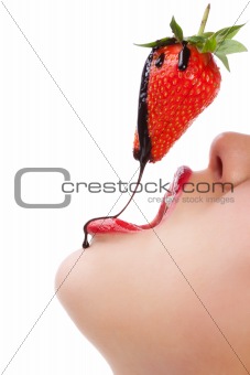girl eating strawberry with chocolate sauc