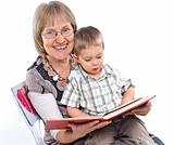 Grandmother and grandson reading a book