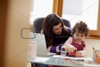 Multitasking mother with her daughter