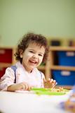 little girl eating lunch in kindergarten