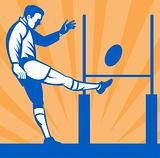 Rugby player kicking ball at goal post