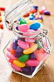 Colorful jelly beans in a bottle - very shallow depth of field